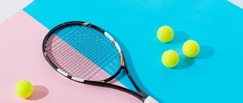 Raqueta de tenis y pelotas de tenis amarillas sobre fondo rosa y azul.