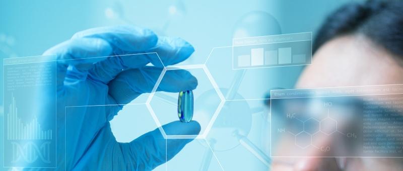 Mano con guante azul sosteniendo una cápsula con superposiciones científicas digitales que muestran fórmulas químicas y gráficos de datos.