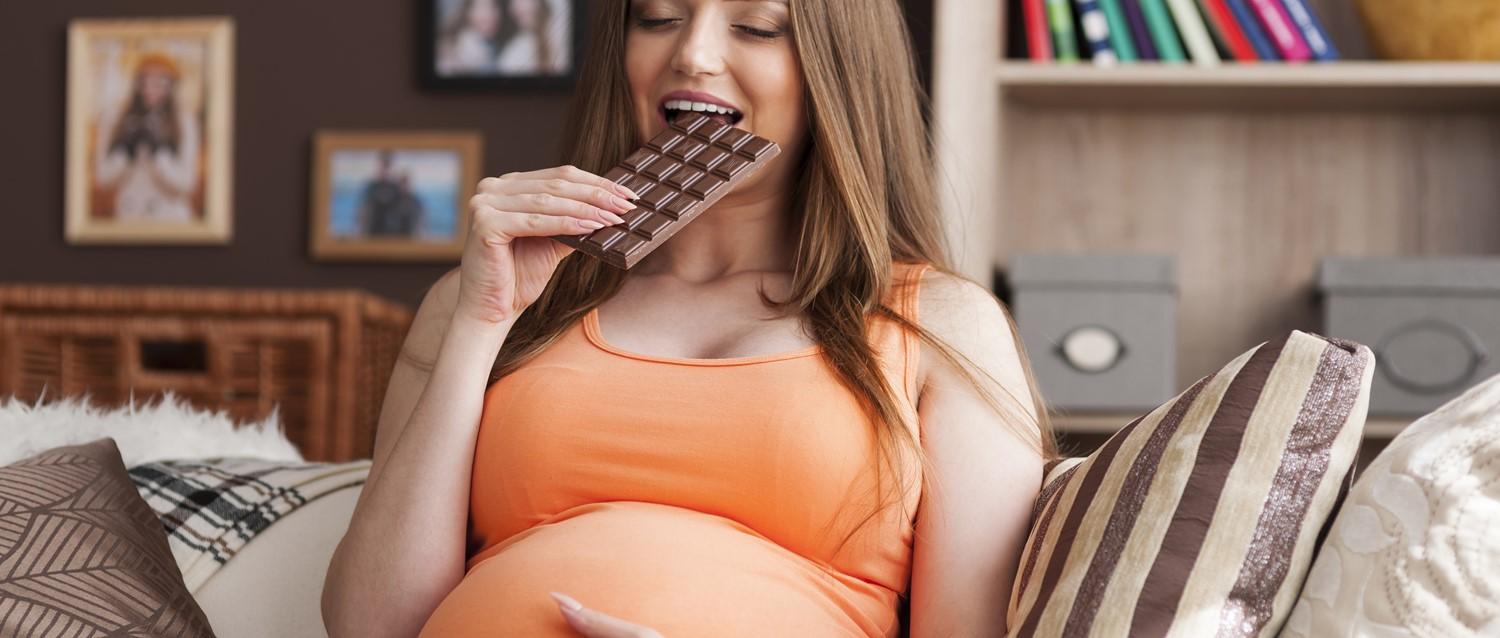 Pregnant woman eating chocolate